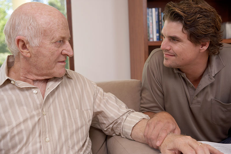 Family caregiver calming senior with dementia and aggression