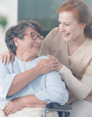 Caregiver Holding Hand of Elderly Woman